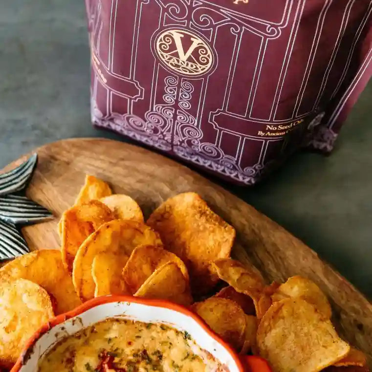 Thick-cut Vandy Smokehouse BBQ chips piled on a wooden board