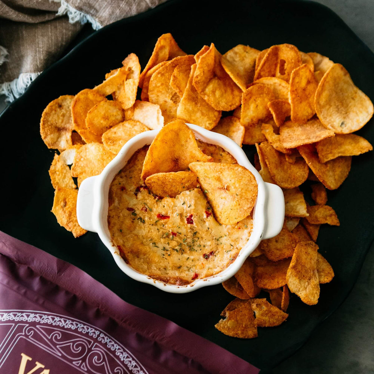 Thick-cut Vandy Smokehouse BBQ chips piled on a wooden board