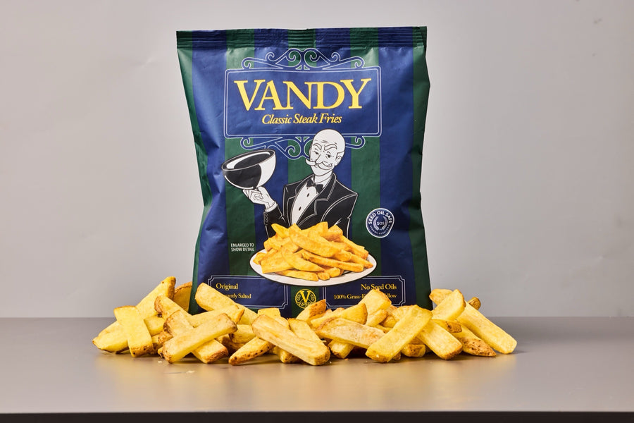 A bag of Vandy Classic Steak Fries, Original, with a pile of golden steak fries in front of it